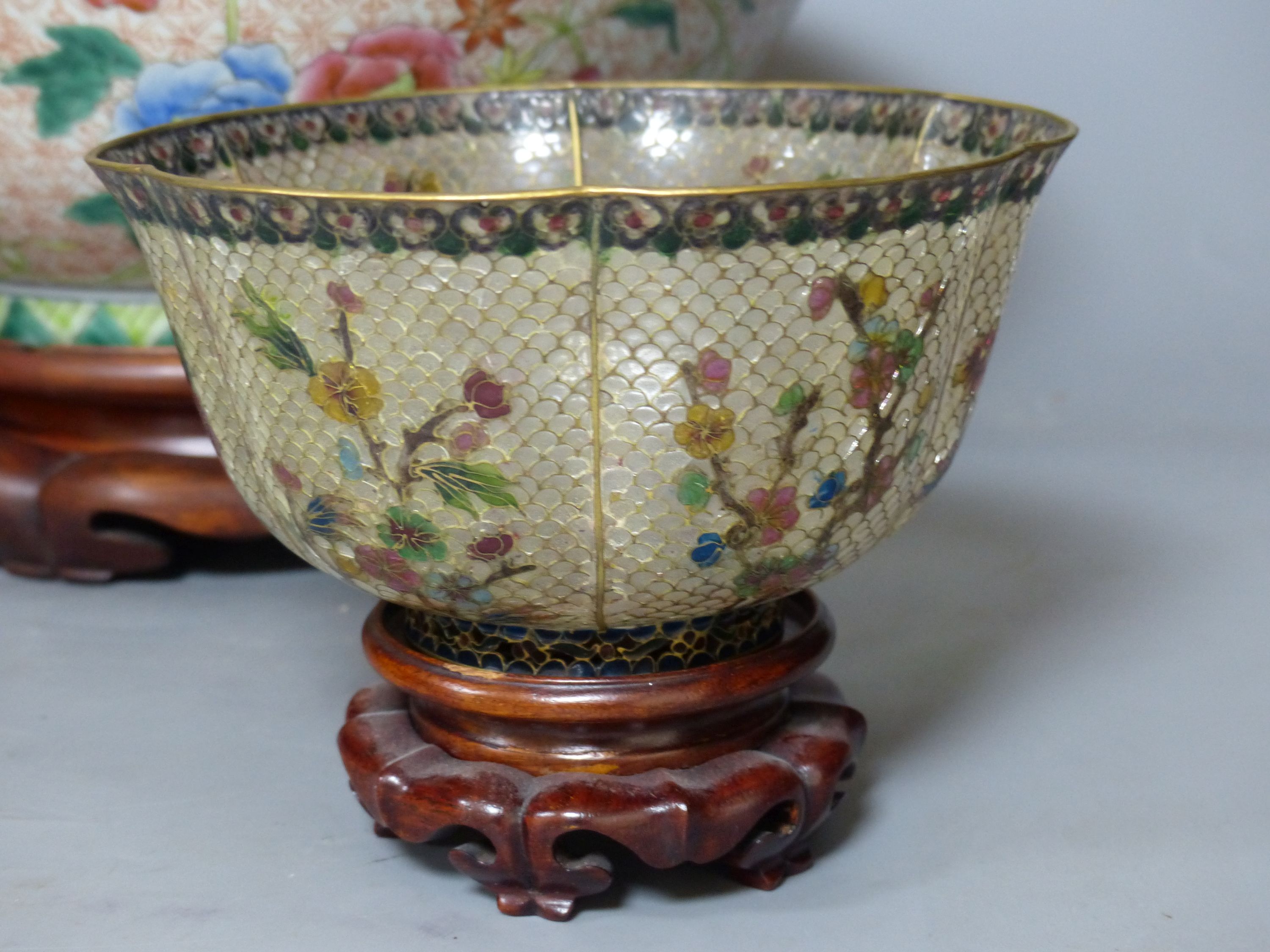 A Chinese plique a jour enamel bowl on stand, and a Chinese famille rose bowl on stand, largest 33cm diameter